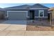 Charming single-story home with a gray exterior, gray roof, stone accents, and low maintenance desert landscaping at 4220 E Kolin Ln, San Tan Valley, AZ 85143