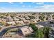 Residential neighborhood with well-maintained homes, lush trees, and a view of distant mountains at 4220 E San Angelo Ave, Gilbert, AZ 85234
