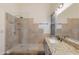 Bathroom featuring a walk-in shower with decorative tile and a granite vanity at 4220 E San Angelo Ave, Gilbert, AZ 85234