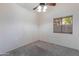Cozy bedroom with a ceiling fan, a window, and plush carpeting at 4220 E San Angelo Ave, Gilbert, AZ 85234