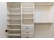 Walk-in closet with custom built-in shelving and drawers for optimal storage at 4220 E San Angelo Ave, Gilbert, AZ 85234