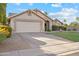 Charming single-story home featuring a well-maintained lawn and a spacious two-car garage at 4220 E San Angelo Ave, Gilbert, AZ 85234
