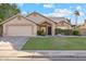 Charming single-story home featuring a well-manicured lawn and a two car garage at 4220 E San Angelo Ave, Gilbert, AZ 85234