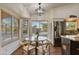 Charming breakfast nook by the kitchen features ample windows, a modern light fixture, and stainless steel appliances at 4220 E San Angelo Ave, Gilbert, AZ 85234