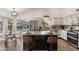 Well-lit kitchen features granite countertops, stainless steel appliances and a central island with seating at 4220 E San Angelo Ave, Gilbert, AZ 85234