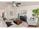 Spacious living room featuring a comfortable sofa, stylish decor, and a ceiling fan at 4220 E San Angelo Ave, Gilbert, AZ 85234