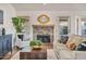 Cozy living room with a brick fireplace, plush seating, and stylish decor at 4220 E San Angelo Ave, Gilbert, AZ 85234