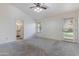Spacious bedroom with carpet, bright window, and an ensuite bathroom at 4220 E San Angelo Ave, Gilbert, AZ 85234
