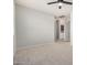 Bedroom with neutral colored walls, carpet, ceiling fan, and open doorways at 4258 E Lexington Ave, Gilbert, AZ 85234