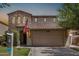 Charming two-story home with a stone facade, tiled roof, well-maintained lawn, and a two-car garage at 4258 E Lexington Ave, Gilbert, AZ 85234
