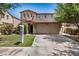 Charming two-story home with a stone facade, tiled roof, well-maintained lawn, and a two-car garage at 4258 E Lexington Ave, Gilbert, AZ 85234