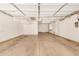 Spacious and well-lit two-car garage with ample storage and a door to the home at 4258 E Lexington Ave, Gilbert, AZ 85234