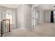 Upstairs hallway featuring neutral walls and carpet, with an arched window at 4258 E Lexington Ave, Gilbert, AZ 85234