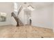Open-concept living room featuring a staircase, tile floors, and modern lighting fixtures at 4258 E Lexington Ave, Gilbert, AZ 85234
