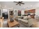 Inviting living room with a fireplace, comfortable sofa, and seamless flow into the kitchen at 4258 E Lexington Ave, Gilbert, AZ 85234