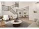 Elegant living room featuring a staircase, stylish furnishings, and a spacious dining area at 4258 E Lexington Ave, Gilbert, AZ 85234