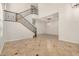 Spacious living room with staircase, tile flooring, and ample natural light at 4258 E Lexington Ave, Gilbert, AZ 85234