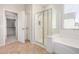 This main bathroom features a glass enclosed shower, tub, and tiled floors at 4258 E Lexington Ave, Gilbert, AZ 85234