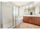 Bright main bathroom features a tiled floor, dual sink vanity, a shower and a soaking tub at 4258 E Lexington Ave, Gilbert, AZ 85234