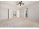 Spacious main bedroom featuring neutral colors, a ceiling fan, and an open doorway to the upper floor at 4258 E Lexington Ave, Gilbert, AZ 85234