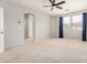 Bright main bedroom featuring carpet, light gray walls, ceiling fan, and windows with curtains at 4258 E Lexington Ave, Gilbert, AZ 85234