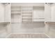 Walk-in closet featuring carpet, white walls, wooden racks and white shelving at 4258 E Lexington Ave, Gilbert, AZ 85234