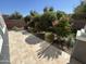 Tile backyard with desert landscaping, trees, flowering bushes and decorative rock at 4490 S Montana Dr, Chandler, AZ 85248