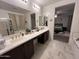 Bright bathroom with double sinks, walk in shower, and view of the bedroom at 4490 S Montana Dr, Chandler, AZ 85248