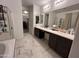 Bright bathroom with double sinks, walk in shower, and walk in closet at 4490 S Montana Dr, Chandler, AZ 85248