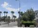 View of gated community featuring lush palm trees, desert landscaping, and stone entry at 4490 S Montana Dr, Chandler, AZ 85248