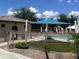 Community pool area featuring mature trees, desert landscaping, lounge chairs, and shade canopies at 4490 S Montana Dr, Chandler, AZ 85248