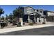 Charming gray two-story home featuring stone accents, a well-manicured yard, and an attached two-car garage at 4490 S Montana Dr, Chandler, AZ 85248