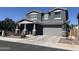 Charming two-story home featuring a gray facade, well-manicured landscaping, and an attached two-car garage at 4490 S Montana Dr, Chandler, AZ 85248
