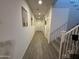 Hallway featuring wood-look tile flooring and access to stairs and multiple rooms at 4490 S Montana Dr, Chandler, AZ 85248