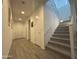Hallway featuring stairs, wood-look tile flooring, and multiple doorways at 4490 S Montana Dr, Chandler, AZ 85248