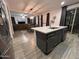 Kitchen island with stainless steel appliances and view to living room at 4490 S Montana Dr, Chandler, AZ 85248