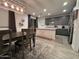 Dining room features wood table, bench, chandelier and open view to kitchen at 4490 S Montana Dr, Chandler, AZ 85248