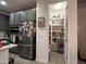 Modern kitchen features stainless steel appliances, gray cabinets and a pantry at 4490 S Montana Dr, Chandler, AZ 85248