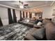 Spacious living room with an oversized sectional, ceiling fan and neutral color palette at 4490 S Montana Dr, Chandler, AZ 85248