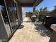 Covered tile patio with sliding glass doors, decorative rock landscaping and BBQ at 4490 S Montana Dr, Chandler, AZ 85248