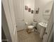Cozy half-bathroom featuring a pedestal sink, toilet, and decorative art at 4490 S Montana Dr, Chandler, AZ 85248