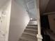 Carpeted staircase with white railing and a wall-mounted light for added visibility at 4490 S Montana Dr, Chandler, AZ 85248