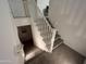 Open staircase features a white railing, carpeted steps and a small wall light at 4490 S Montana Dr, Chandler, AZ 85248
