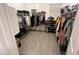 Spacious walk-in closet featuring neutral paint, tile floors, and custom shelving for optimal organization at 4490 S Montana Dr, Chandler, AZ 85248