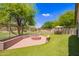 Beautiful backyard featuring a brick fire pit and ample room for outdoor entertaining at 4518 W Carson Rd, Laveen, AZ 85339