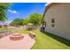 Backyard showcasing a fire pit, artificial grass, and patio furniture for relaxing outdoor enjoyment at 4518 W Carson Rd, Laveen, AZ 85339