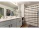 Bathroom featuring dual sinks, a large mirror, and walk-in closet for ample storage at 4518 W Carson Rd, Laveen, AZ 85339