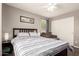 Bedroom showcasing a bed, window views, and a cozy loveseat for relaxation at 4518 W Carson Rd, Laveen, AZ 85339