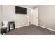 This is a bedroom with taupe colored walls, gray carpet and a TV mounted on the wall at 4518 W Carson Rd, Laveen, AZ 85339