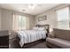 This is a bedroom featuring a bed, a window with curtains and a loveseat at 4518 W Carson Rd, Laveen, AZ 85339